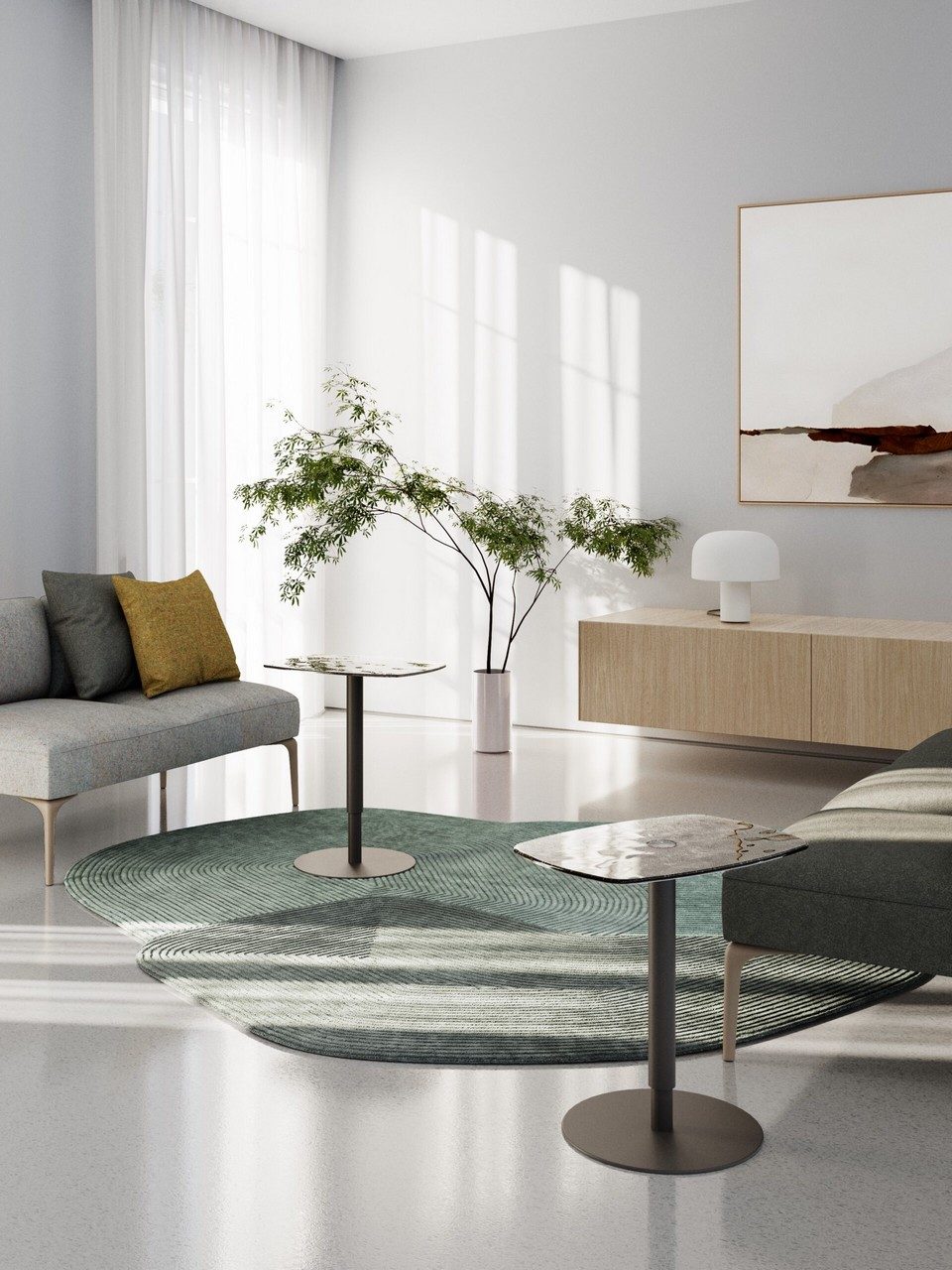 Aménagement d'un espace d'accueil contemporain avec deux tables KOBI réglables et des canapés lounge pour une ambiance résidentielle au bureau.