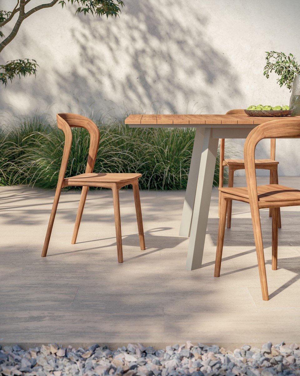 Gros plan sur la chaise MILLER en teck massif soulignant son design organique et sa résistance pour l'extérieur.