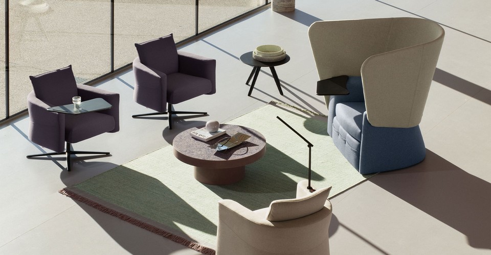 Vue en plongée d'une zone lounge équipée du fauteuil VIP SOLO avec sa tablette de travail orientable.