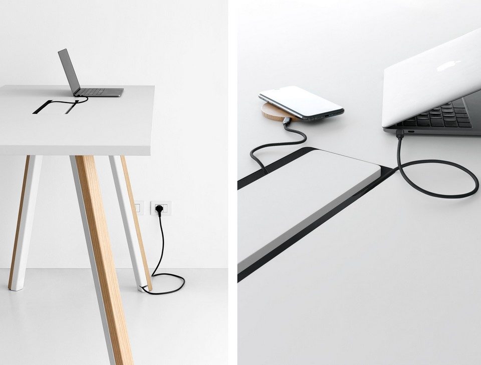 Zoom sur le système d'électrification et de câblage dissimulé dans le piétement d'une table de coworking blanche ORI Wood Mobilier.